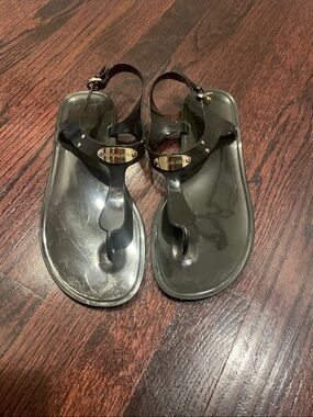 Michael Kors black jelly thong sandals with gold logo